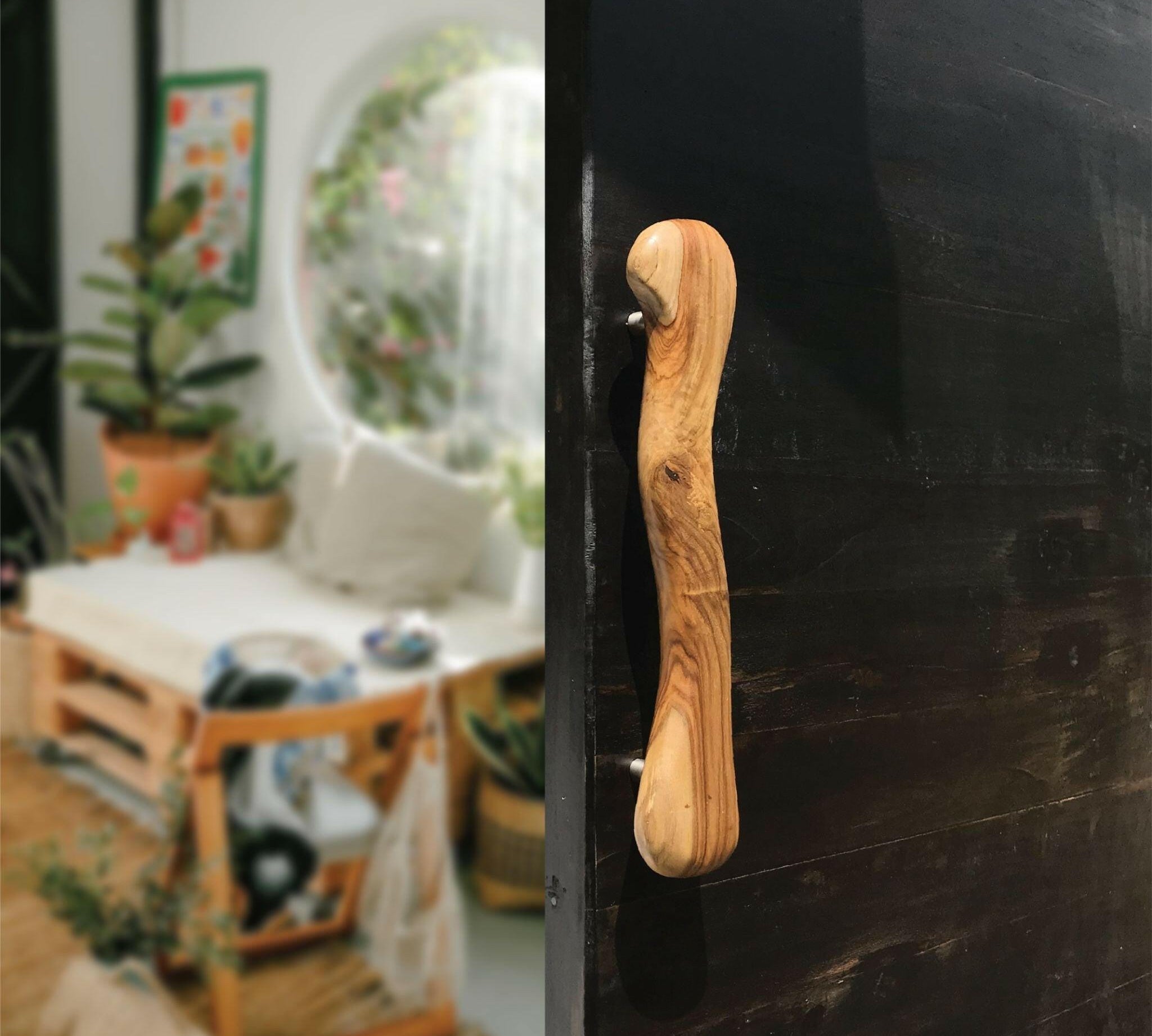 Wood Ceylon wooden door handle with smooth natural finish on black door in cozy living space