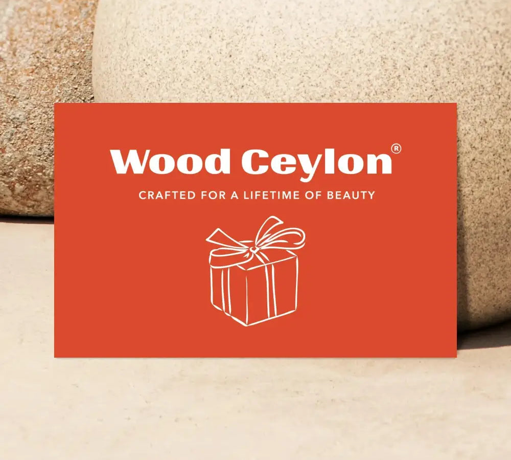 Wood Ceylon gift card in burnt orange with white text and gift box illustration on natural stone background