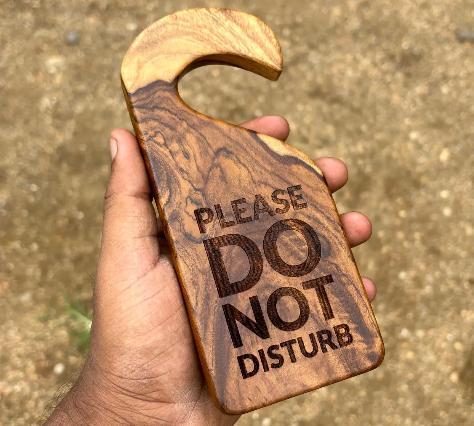 Wood Ceylon wooden door sign hangers with please do not disturb engraved text held in hand