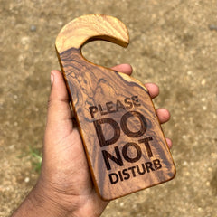Wood Ceylon wooden door sign hangers with please do not disturb engraved text held in hand