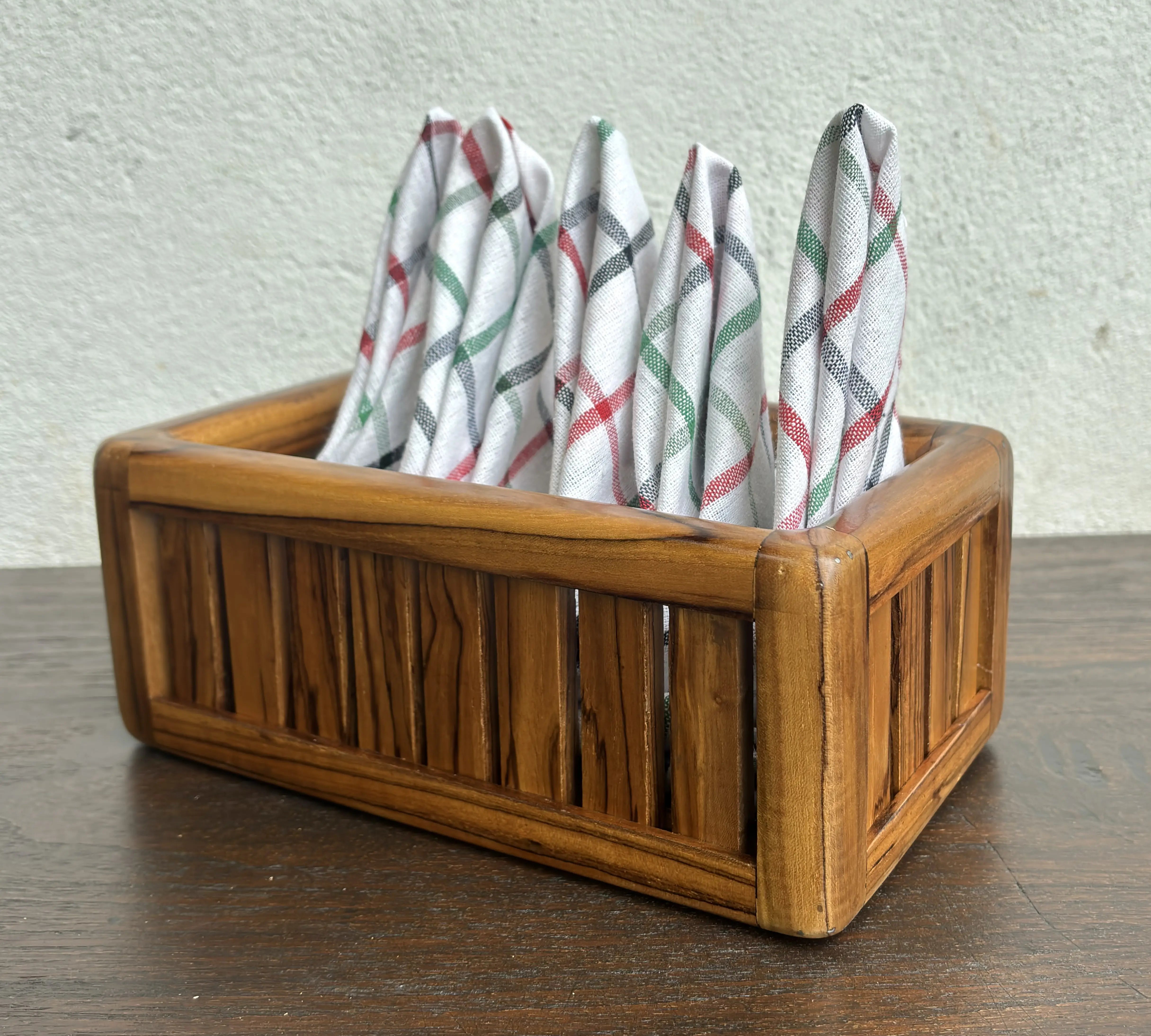 Wood Ceylon wooden towel box storage with vertical slats and folded patterned towels inside