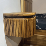 Wood Ceylon floating nightstand with drawer in natural wood finish mounted on wall next to bed