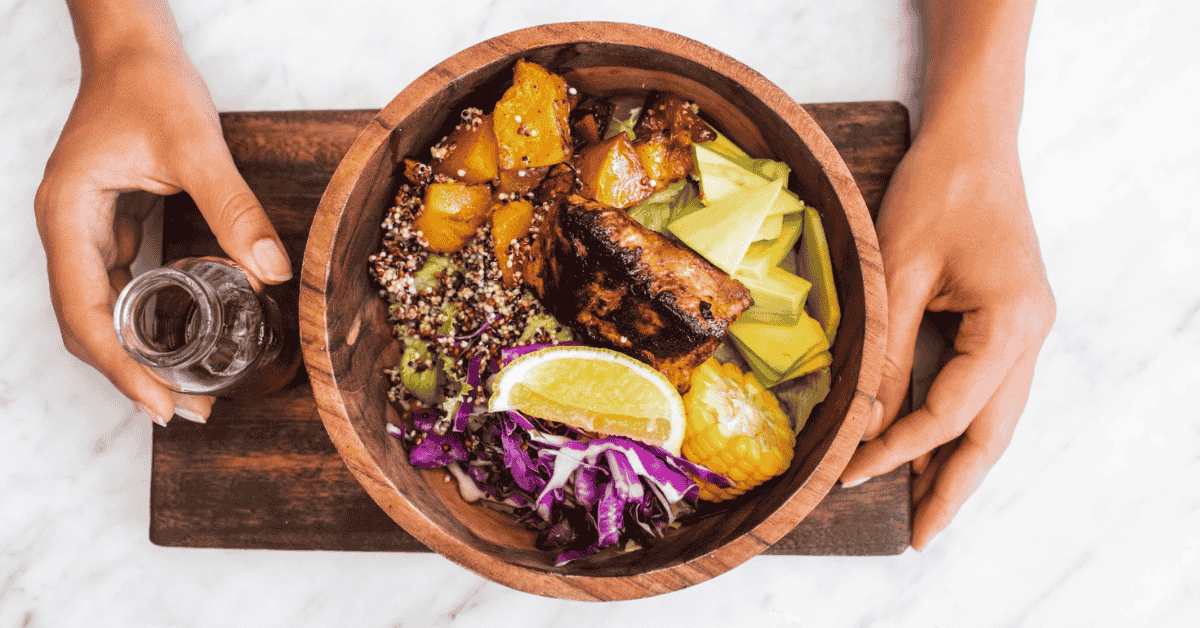 Healthy meal served in a wooden bowl with food safe wood finishes on the tray and bowl