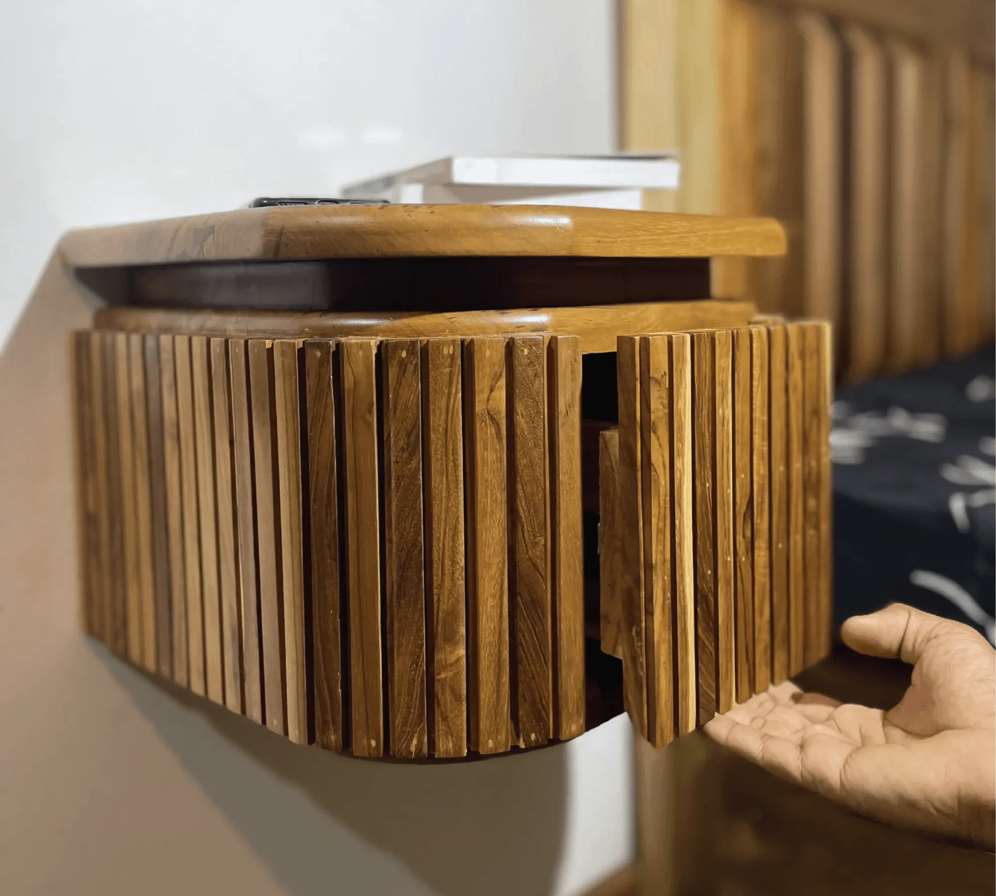 Wood Ceylon wooden floating nightstand with drawer mounted on wall showing open door